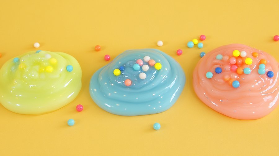 Three types of slime displayed in clear bowls with text labels